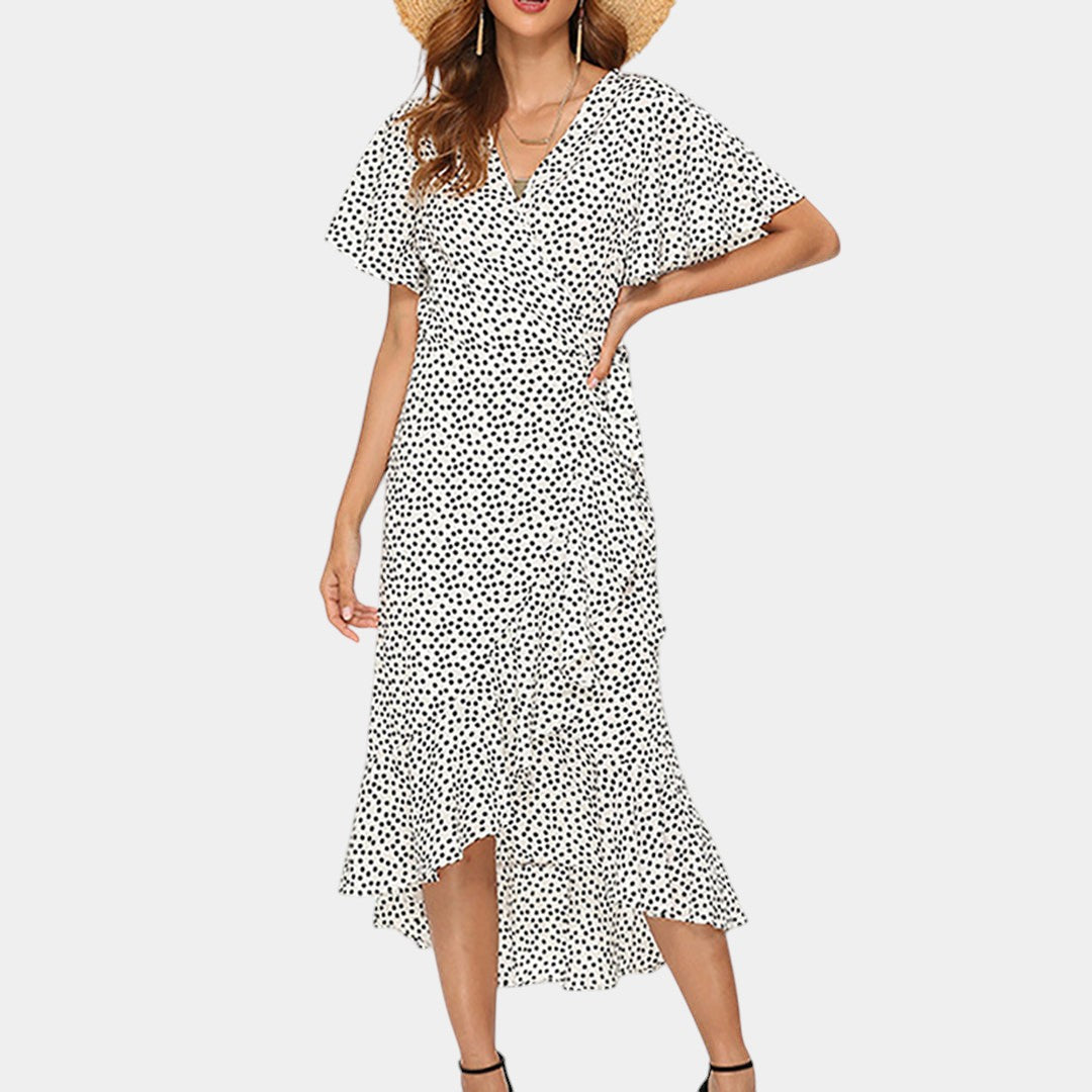 Dames wikkeljurk met V-hals, speelse print en asymmetrische rok – perfect voor zomer, strand en tuinfeest
