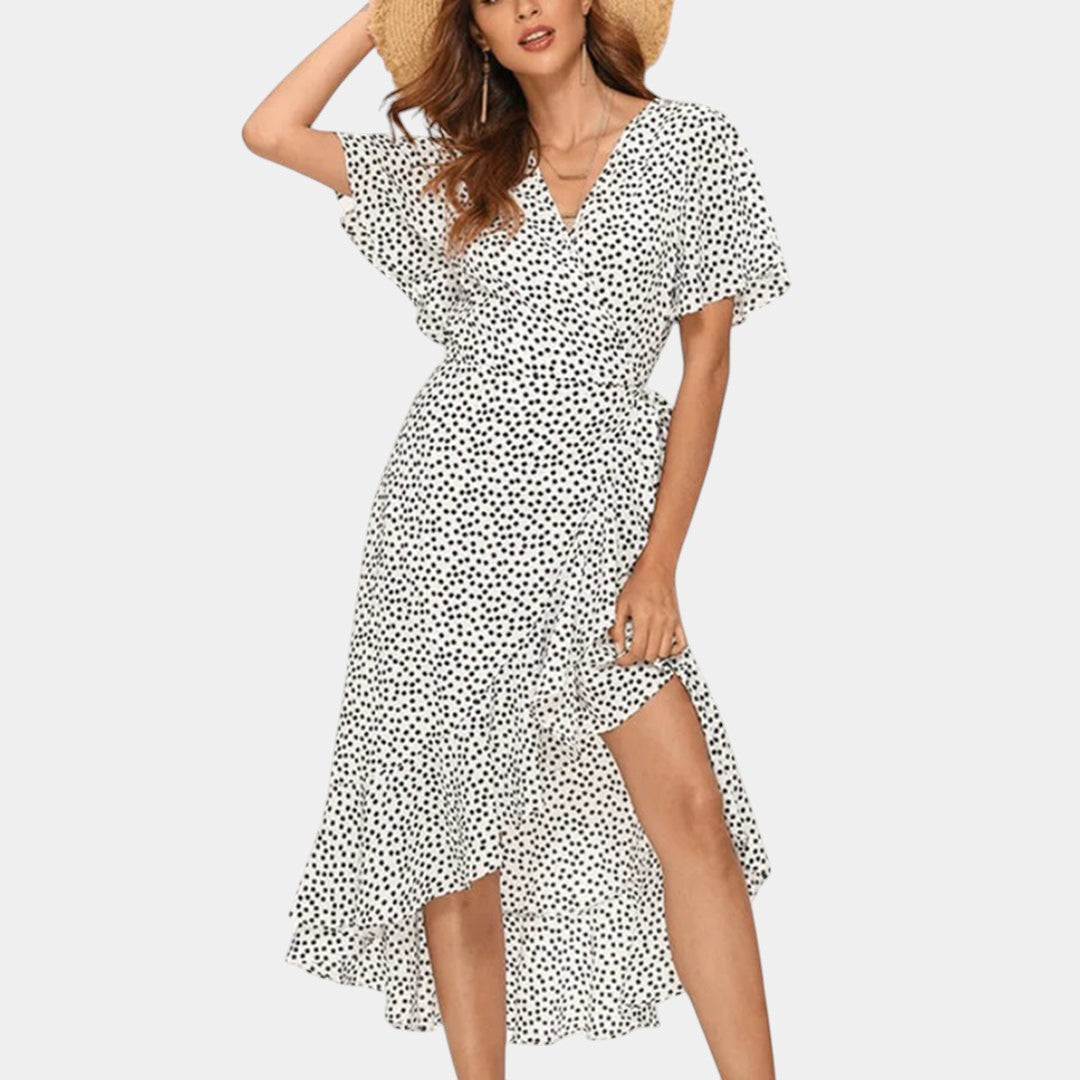 Dames wikkeljurk met V-hals, speelse print en asymmetrische rok – perfect voor zomer, strand en tuinfeest