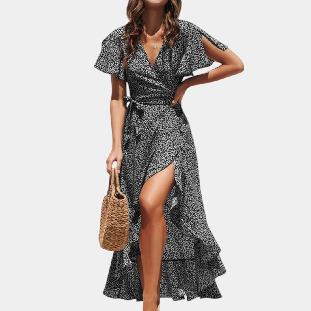 Dames wikkeljurk met V-hals, speelse print en asymmetrische rok – perfect voor zomer, strand en tuinfeest