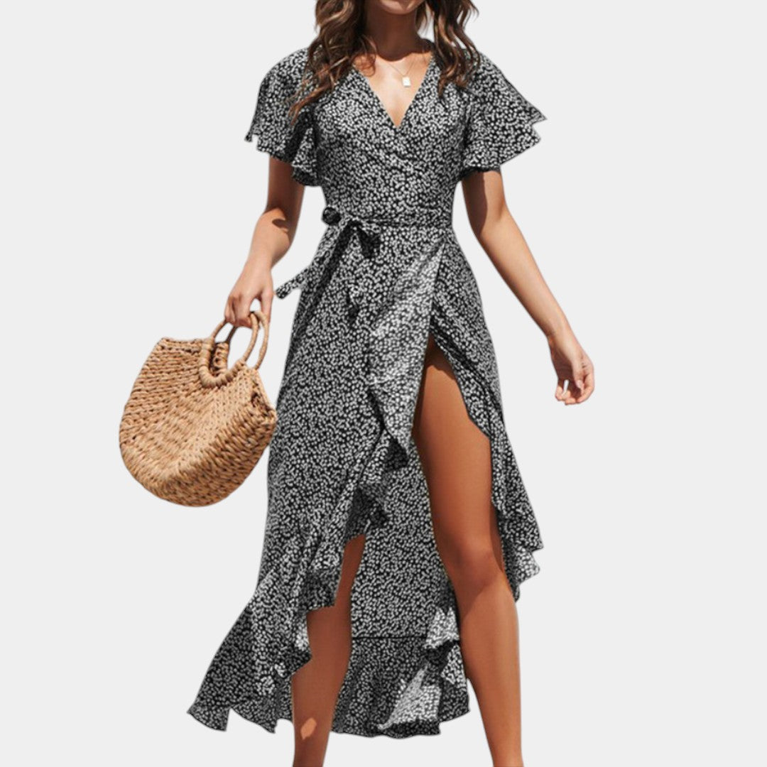 Dames wikkeljurk met V-hals, speelse print en asymmetrische rok – perfect voor zomer, strand en tuinfeest