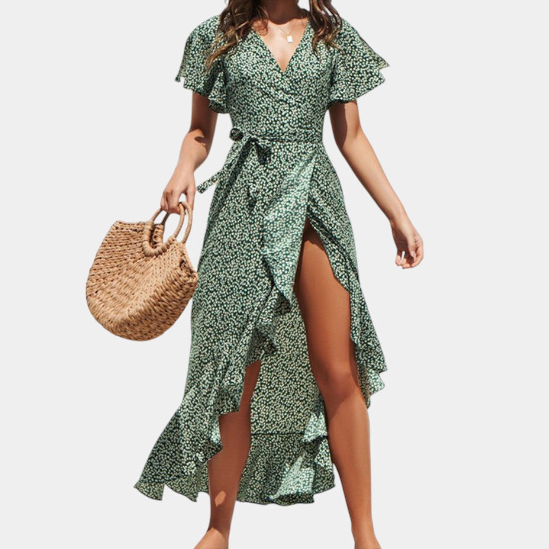 Dames wikkeljurk met V-hals, speelse print en asymmetrische rok – perfect voor zomer, strand en tuinfeest