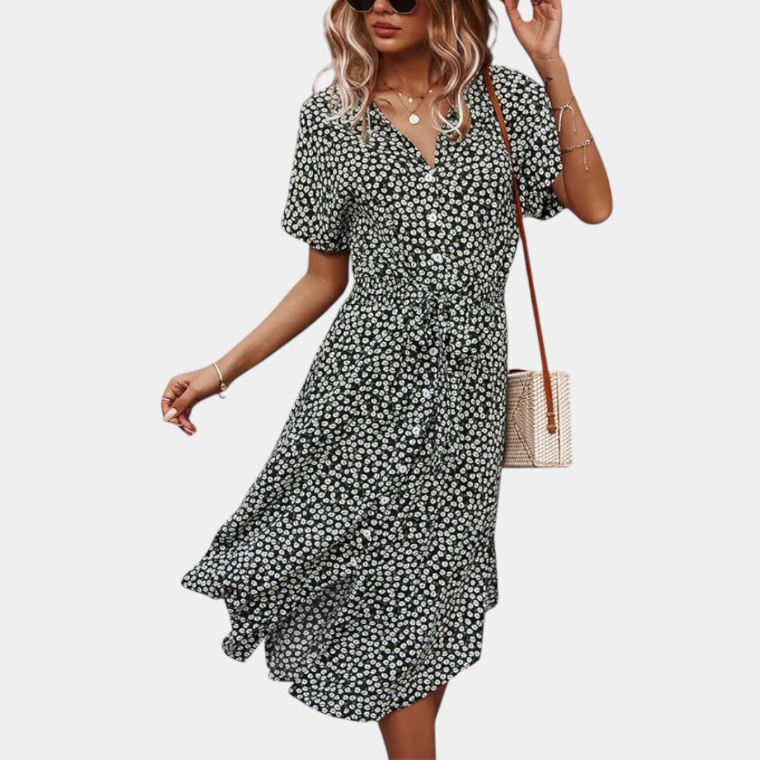 Dames midi-jurk met bloemenprint, korte mouwen en flatterende pasvorm, ideaal voor zomerse dagen en casual gelegenheden.