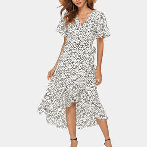Dames wikkeljurk met V-hals, speelse print en asymmetrische rok – perfect voor zomer, strand en tuinfeest