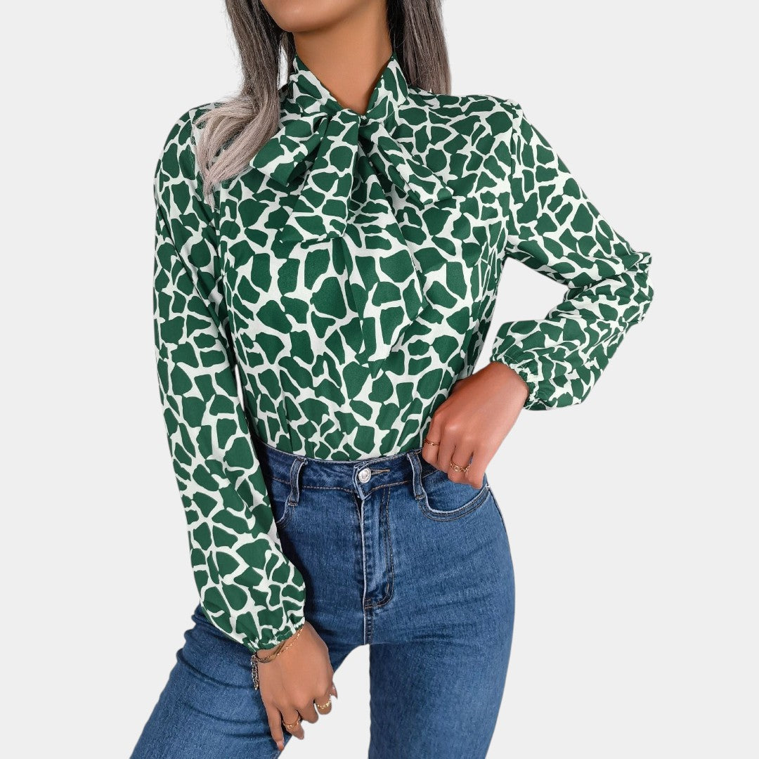 Dames blouse met stippenpatroon, strikdetail en elastische manchetten, geschikt voor zowel zakelijke als casual outfits