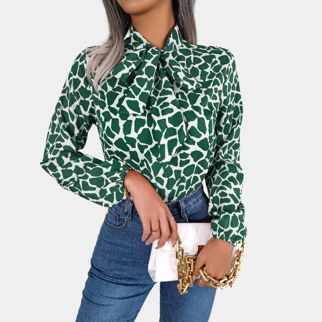 Dames blouse met stippenpatroon, strikdetail en elastische manchetten, geschikt voor zowel zakelijke als casual outfits