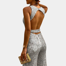 Dames glitter jumpsuit met flatterende pasvorm en glanzend design, perfect voor bruiloften, gala’s en feestelijke avonden.