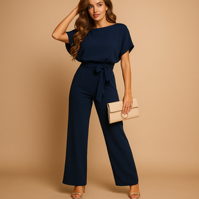 Dames jumpsuit met halternek, open rug en glitterstof – ideaal voor feestjes, gala’s en elegante gelegenheden.