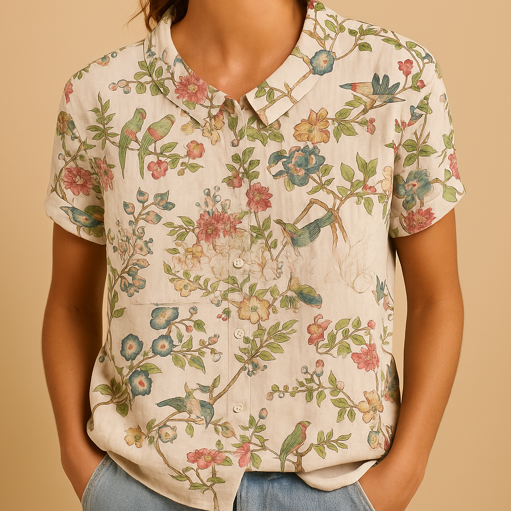 Vrouw draagt een luchtige blouse met vrolijke bloemenprint, ideaal voor zomerse dagen en casual outfits