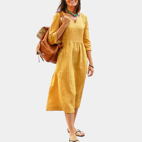 Hoog getailleerde dames midi-jurk met V-hals en halflange mouwen, geschikt voor formele en casual gelegenheden.