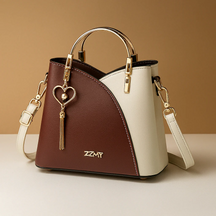 Schoudertas voor dames met geometrisch patroon, metalen accenten en verstelbare draagoptie, geschikt voor dagelijks en formeel gebruik.