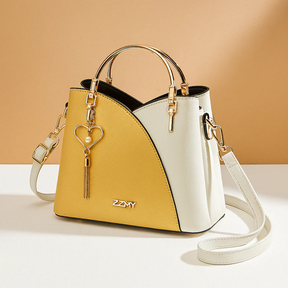 Schoudertas voor dames met geometrisch patroon, metalen accenten en verstelbare draagoptie, geschikt voor dagelijks en formeel gebruik.