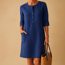 Casual dames tuniekjurk met knopen, zakken en opgerolde mouwen – ideaal voor dagelijks comfort en ontspannen stijl.